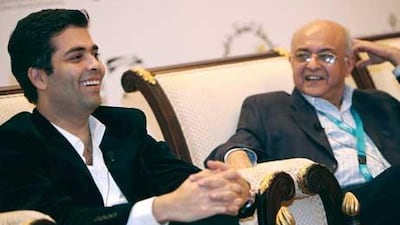 Amit Khanna, right, the head of Reliance Big Entertainment, and the Bollywood director Karan Johar speak at the event.