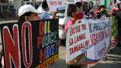 Demonstrators protest against successive oil price increase in recent weeks, in front of a petrol station in Philippines' capital Manila. AFP