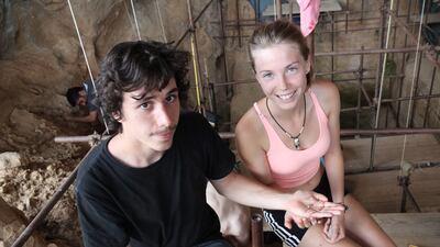 Two archaeological students Camille Jacquey, right, and Valentin Loescher, left, posing with a 560,000-year-old tooth they found on July 23, 2015, at the Caune de l’Arago cave, near Tauvatel, south-western France. It is considered as a major discovery by archeologists as this tooth is 100,000 years older than the Tautavel Man (450,000-year-old fossil remains of the hominid Homo erectus). Denis Dainat / Epcc-Cerp Tauvatel / EPA