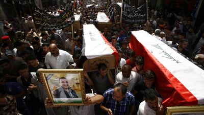 Iraqi mourners attend the funeral of security forces who were killed in a suicide attack on an Iraqi police base north of Baghdad on June 2, 2015. The attack in the holy Shiite city of Najaf in southern Iraq killed at least 37 people. Haidar Hamdani/AFP Photo