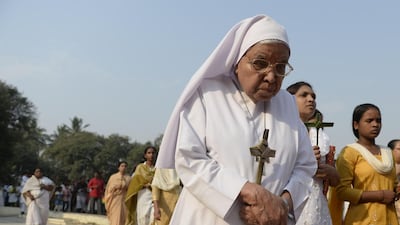 An Indian Catholic nun carries a palm cross during a Passion play at The Saint Joseph's church in Hyderabad. Noah Seelam / AFP Photo