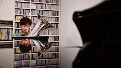 Japanese tuba player Kazuhiko Sato records himself at his home in Tokyo as members of the New Japan Philharmonic Orchestra prepare for their latest recital. AFP