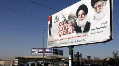A poster depicting Iran's supreme leader Ayatollah Khamenei, right, and Ayatollah Mohammed Sadiq Al Sadr, the late father of the radical anti-US cleric Muqtada Al Sadr, in Baghdad, Iraq.