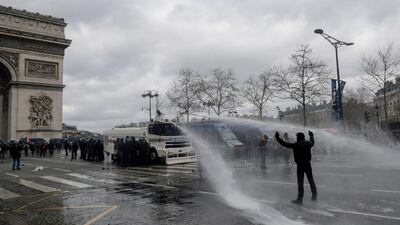A protester gestures at riot police on the Champs-Elysees on March 16, 2019. AFP