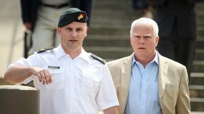 In this June 27, 2019, filke photo. Maj. Mathew Golsteyn, a former Army Special Forces soldier, leaves the Fort Bragg courtroom facility with his civilian lawyer, Phillip Stackhouse, right, after an arraignment hearing. AP