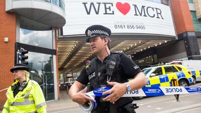 A police officer marks out a cordon using tape following an evacuation at the Arndale shopping mall in Manchester. Matthew Lloyd / Bloomberg News