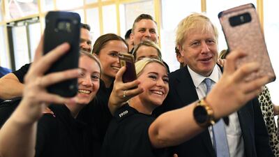 Boris Johnson poses for selfies with supporters during the Conservative leadership race earlier this month. Dylan Martinez / Pool via Bloomberg