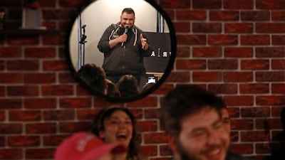 Hussein al-Rawi performs during a comedy night titled "Styria" which is an Arabic mash-up of Syria and hysteria, in Damascus on April 24, 2023. Every week, members of Syria's first stand-up comedy troupe crack jokes about daily struggles like power cuts and fuel shortages, lightening the mood for despondent Damascenes after 12 years of war. (Photo by LOUAI BESHARA / AFP)