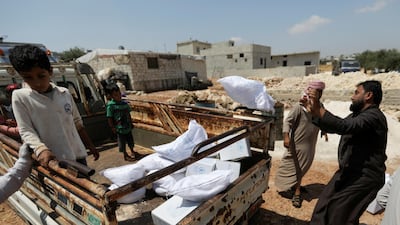 An internally displaced Syrian boy stands next to boxes of humanitarian aid in rebel-held Idlib, Syria, accessible by the Bab Al Hawa aid crossing. Reuters