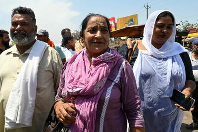 Indian citizens returned from Pakistan via the Wagah-Attari border post on Thursday as tensions escalate. AFP