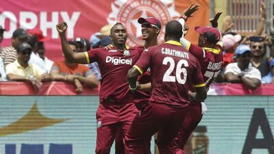 West Indies players celebrate after defeating India by one run in the first Twenty20 in Florida. Lynne Sladky / AP Photo