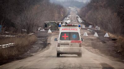 An ambulance travels towards a checkpoint set up by the army on the road between Bakhmut and Luhanske, near the frontline in eastern Ukraine. AP