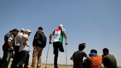 A Palestinian demonstrator with an amputated leg takes part in a protest marking the 71st anniversary of the 'Nakba', when hundreds of thousands fled or were forced from their homes in the war surrounding Israel's independence in 1948, near the Israel-Gaza border fence, east of Gaza City. Reuters