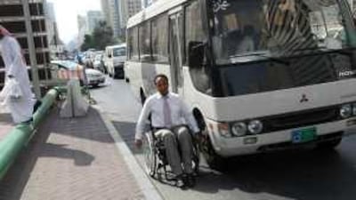 Hani Mohamed Yousif is forced to take to the roads in Abu Dhabi because of the high kerbs and lack of ramps for wheelchairs.