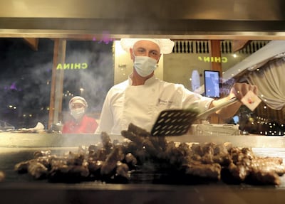 A chef makes Bosnian kebabs at Global Village. Chris Whiteoak / The National
