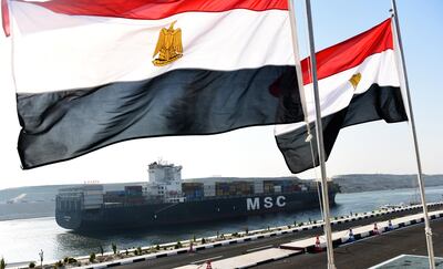A cargo ship crosses a new waterway at the Suez Canal during its opening ceremony on August 6, 2015, in the port city of Ismailiya. Egyptian President Abdel Fattah al-Sisi staged a lavish ceremony to unveil the 'new' Suez Canal. AFP.