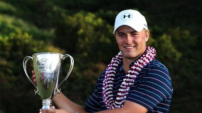 Jordan Spieth celebrates with the trophy after winning the Tournament of Champions in Hawaii. Spieth will now make his way to the UAE for his Abu Dhabi HSBC Golf Championship debut. Sam Greenwood / Getty Images