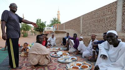 Sudanese wait for sunset to break their daytime fast during the Holy Islamic month of Ramadan, amid a curfew due to the coronavirus pandemic, in a street in the capital Khartoum, Sudan, Monday, April 27, 2020. AP
