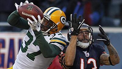 Green Bay Packers' cornerback Sam Shields, left, intercepts a ball intended for the Chicago Bears wide receiver Johnny Knox.