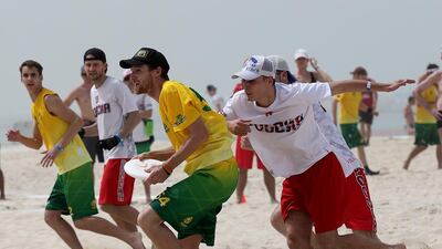 Australia, in green, took on Russia, in white, during the World Championships of Beach Ultimate on Monday. Satish Kumar / The National