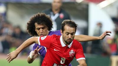 Everton Ribeiro tussles with Omar Abdulrahman during Al Ahli's Champions League clash with Al Ain. Pawan Singh / The National