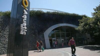 Patrons walk near the entrance of Sydney Aquatic Centre in Sydney on February 24, 2014. Before the 2000 summer Olympics, the site west of Sydney where the 1580-acre Sydney Olympic Park was built was a grungy, desolate wasteland of slaughterhouses, garbage dumps and factories. Since the games, it has slowly developed into its own suburb with hotels, offices, restaurants and parklands. The park now hosts thousands of events each year, from music festivals to sports to business conferences, drawing more than 12 million annual visitors. Rick Rycroft / AP Photo