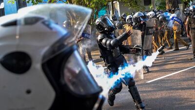 Tear gas is hurled by police as Sri Lankan protesters urge the government to hold a local council election as scheduled, in Colombo. AFP