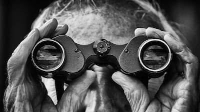 A racegoer watches the action through binoculars at Bath Racecoursein Bath, England. Getty Images