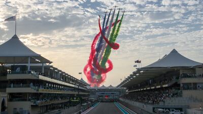 The sky was filled with streaks of red, white, green and black as Al Fursan aerial display team whizzed above Yas Marina Circuit in the UAE capital in their Aermacchi MB-339A jets joined by Etihad Boeing 737 before the start of Abu Dhabi Formula One Grand Prix. Victor Besa / The National