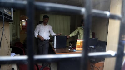 A Central Bureau of Investigation official takes custody of computers of Punjab National Bank branch during a raid in Mumbai, India. Divyakant Solanki/EPA