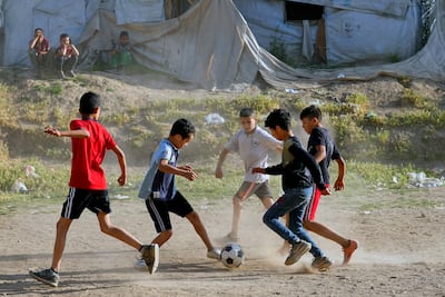 Syrian children play football by their tents at a refugee camp in the town of Bar Elias, in Lebanon's Bekaa Valley, last week. AP Photo