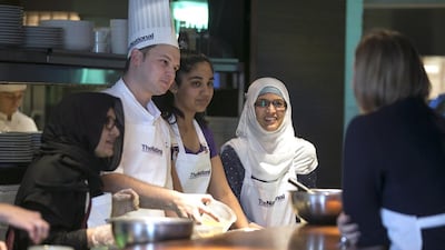 Jordan Annabi, Chef De Cuisine at the Le Royal Meridien hotel in Abu Dhabi, and guests Nabiha Mohamed with daughter, Amina, chat while making desserts. Silvia Razgova / The National