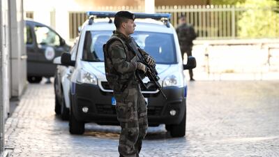 An armed French soldier stands near the site where a car slammed into soldiers on patrol in Levallois-Perret. Stephane De Sakutin.