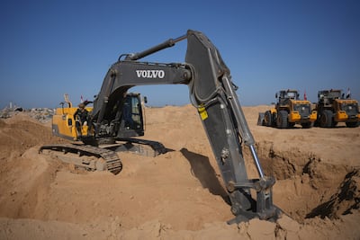 Diggers have been brought into Gaza to aid the search for dead hostages. AP