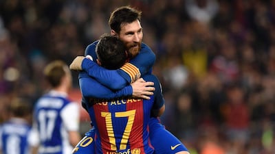 Barcelona's forward Paco Alcacer celebrates a goal with Lionel Messi during the Spanish Primera Liga match against Real Sociedad at Camp Nou in Barcelona on April 15, 2017. Lluis Gene / AFP