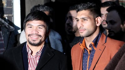 A fight between Manny Pacquiao, left, and Amir Khan, right, in the UAE is edging closer to being confirmed. Martin Willetts / Getty Images