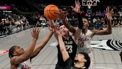 Houston and Colorado players battle for a rebound during an NCAA college basketball game in Kansas City. AP