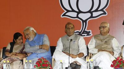 India’s prime minister-elect Narendra Modi, second from left, speaks with BJP leader Sushma Swaraj, as party president Rajnath Singh and LK Advani, right, look on at a function in New Delhi. All three are likely candidates for spots in Mr Modi’s cabinet. Harish Tyagi / EPA / May 17, 2014
