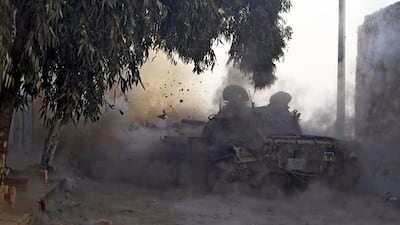 A Free Syrian Army tank fires a shell towards forces loyal to President Bashar Al Assad in Aleppo. An arm of the British defence consultant IHS Jane’s and experts at a nonprofit think tank in London estimate a couple of dozen Americans are fighting with rebels in Syria. Molhem Baraket / Reuters