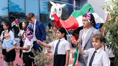 Students await the arrival of Prince Edward.