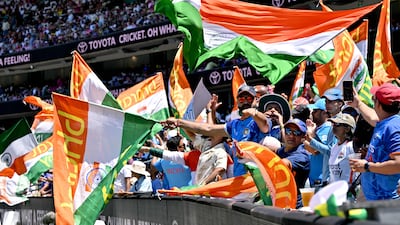 Indian fans cheer in the stands. AFP