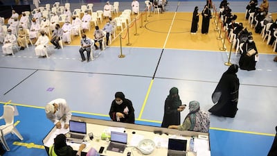 People wait for their turn to get vaccinated against COVID-19 at the Sultan Qaboos Sports Complex in Oman's capital Muscat. AFP