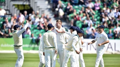 Boyd Rankin celebrates with teammates after taking Ireland's first ever Test wicket. Charles McQuillan / Getty Images