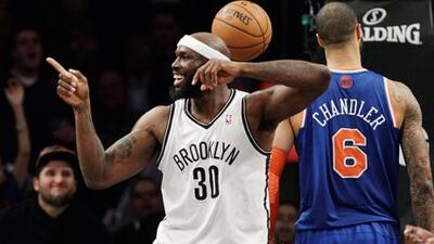 Brooklyn Nets' Reggie Evans celebrates after blocking a shot by New York Knicks' Tyson Chandler.