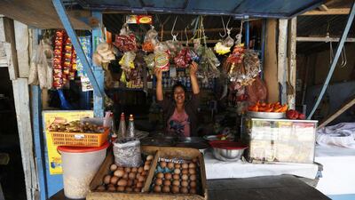 Lucia Liaza, 50, at her market stall where she sells food and spices in Gosen City. Liaza came from the violence-torn city of Ayacucho 20 years ago. She says that just recently has she been able to afford a few luxuries that she couldn’t previously. Mariana Bazo / Reuters