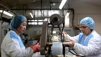 Employees working on the production line at the Pittas Dairy Industries halloumi factory in the Cypriot capital Nicosia. The cheese has been made in Cyprus for centuries by both its Greek and Turkish communities. Florian Choblet/AFP Photo