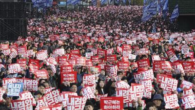 South Korean protesters hold up placards during a rally calling for South Korean President Park Geun-hye to step down in Seoul, South Korea, Saturday, Nov. 12, 2016. (AP Photo/Lee Jin-man)