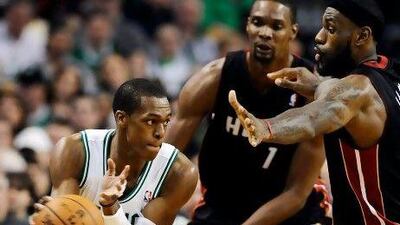 Boston Celtics point guard Rajon Rondo, left, keeps the ball from Miami Heat's Chris Bosh.