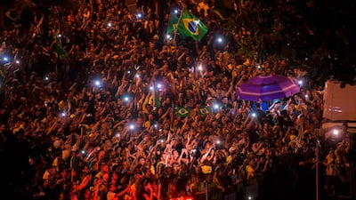 Supporters of Jair Bolsonaro celebrate in front of his house in Rio de Janeiro. AFP