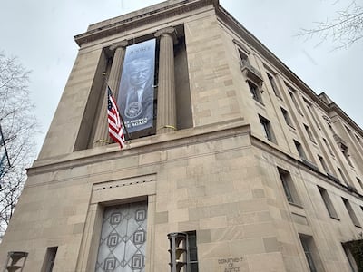 This banner of President Donald Trump was unfurled at the headquarters of the US Department of Justice in Washington on February 19. Thomas Watkins / The National.